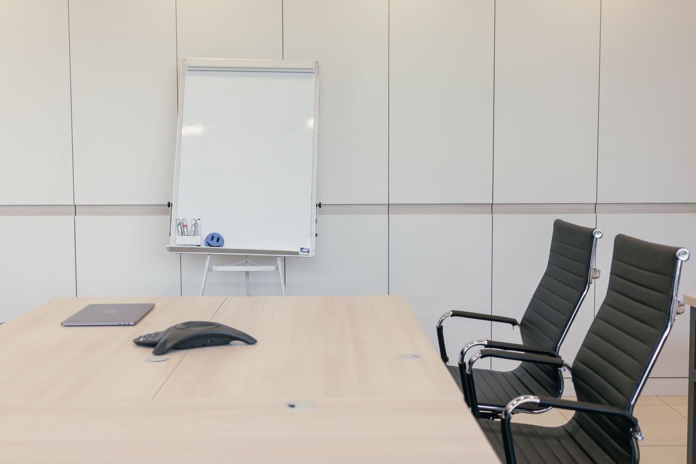 Meeting room with a whiteboard and a conference phone
